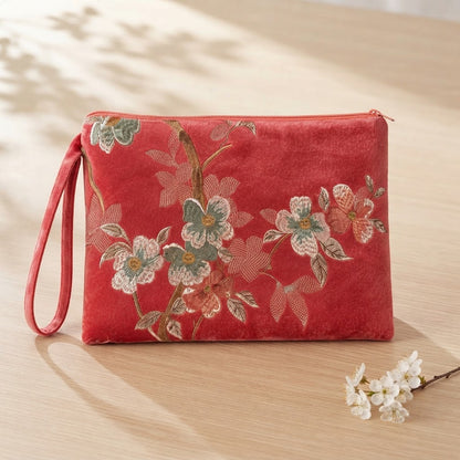 Pink embroidered mahjong clutch with a matching wrist strap