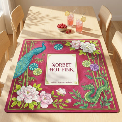 Sorbet Pink Peacock mahjong mat on a dining table with drinks and snacks set beside it
