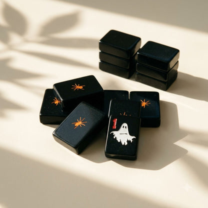The tile backs — a small orange spider centred on every one