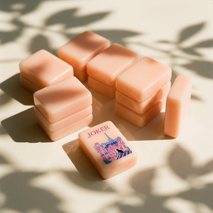 Stacks of strawberry-pink mahjong tiles showing thickness and polished edges