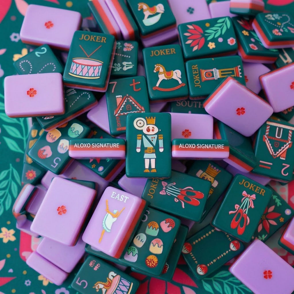 A loose pile of Sugarplum tiles shown close up, green faces, lilac backs and red-banded edges all visible at once