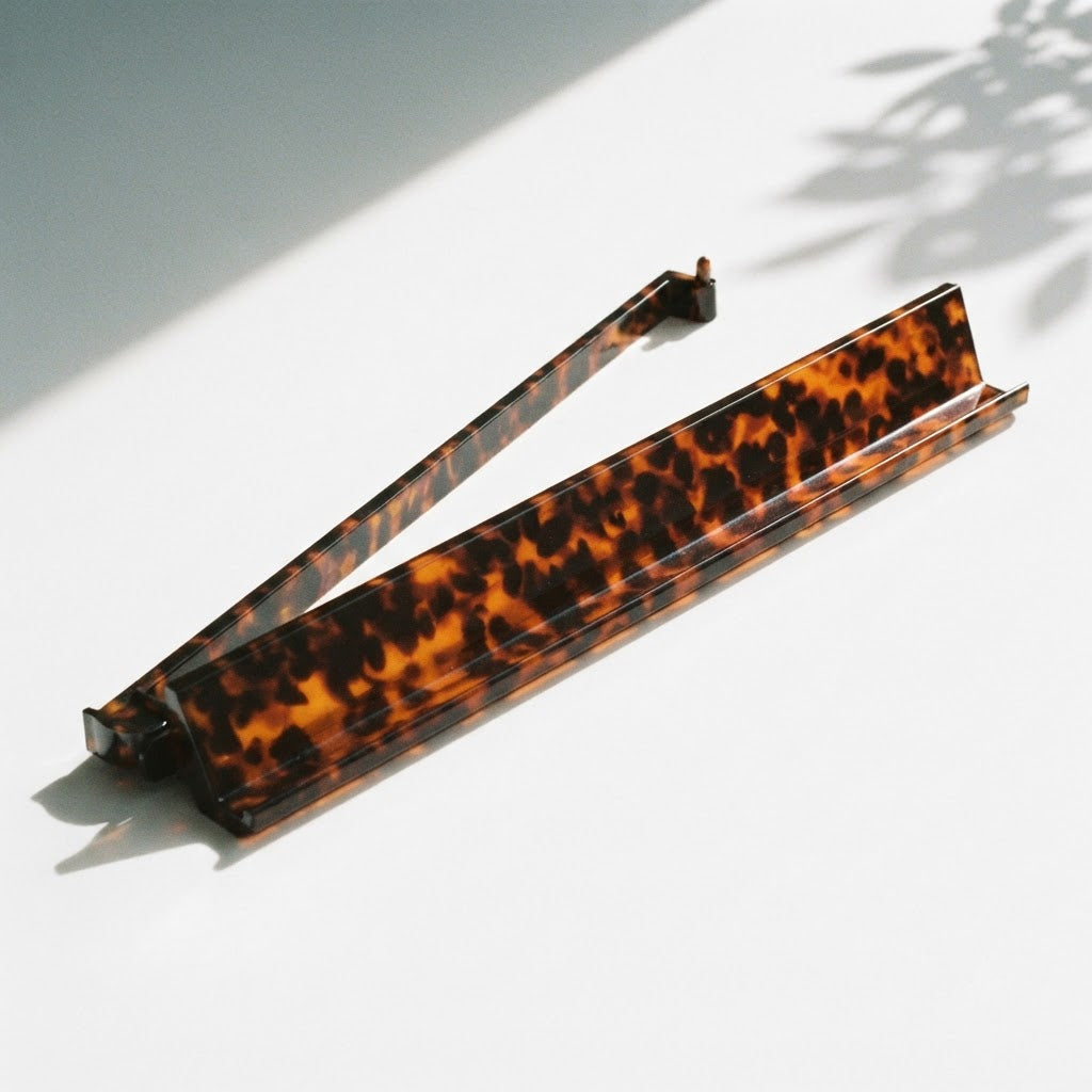 A single Tortoise Shell mahjong rack with its pusher arm swung open